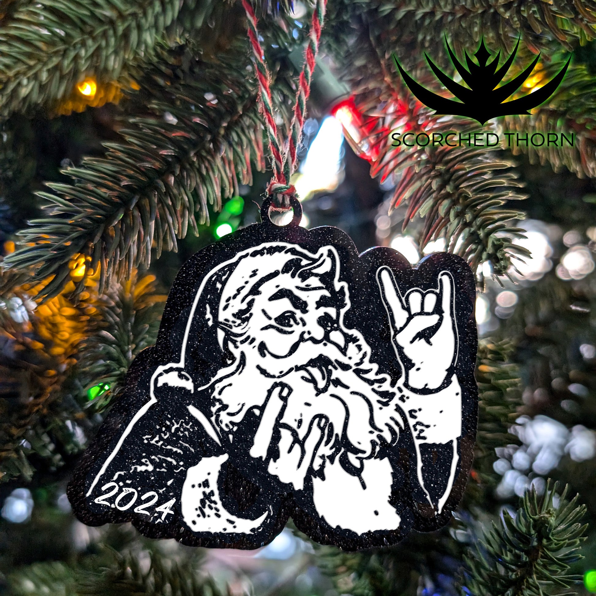 Rocker Santa® “Hail Santa Rocker” acrylic ornament on Christmas tree branch