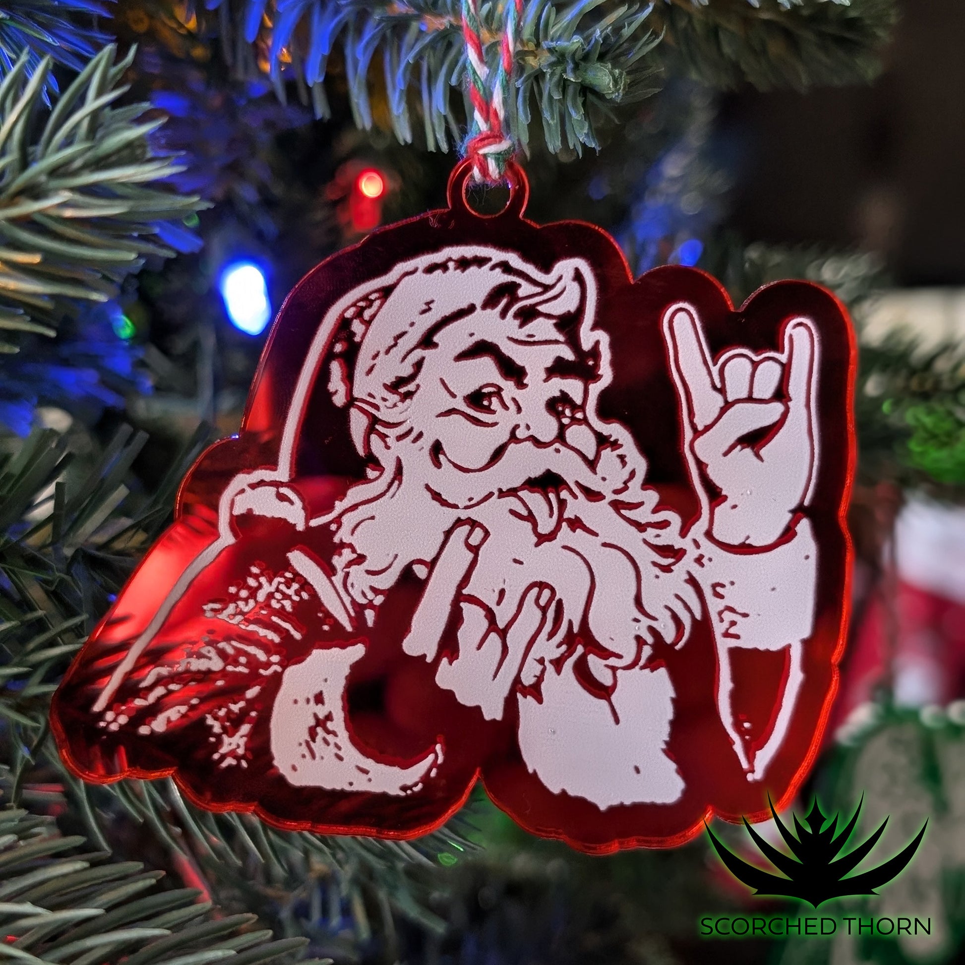 Rocker Santa® “Hail Santa Rocker” acrylic ornament on Christmas tree branch